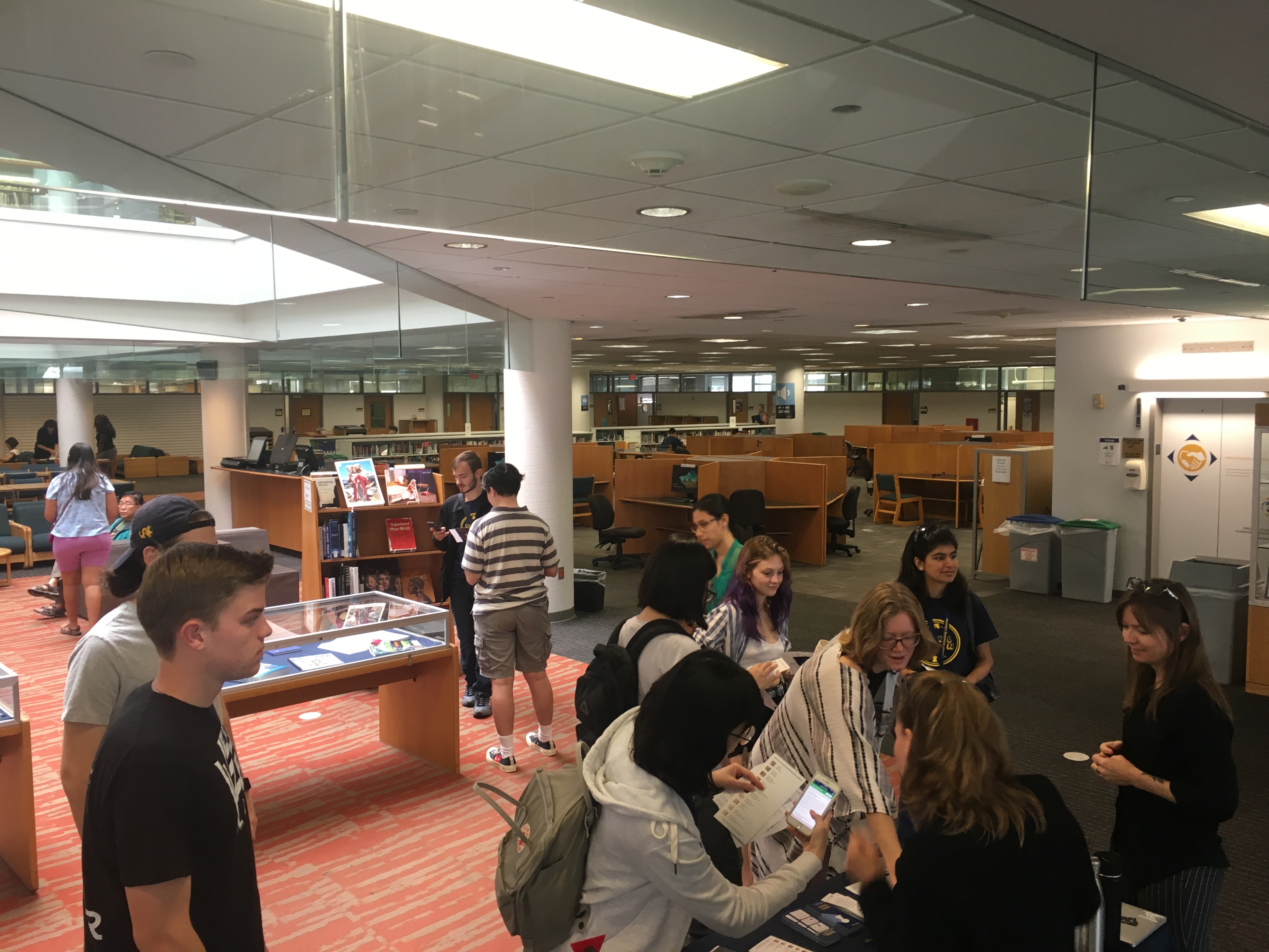 A group of students talk to Libraries staff in the W. W. Hagerty Library